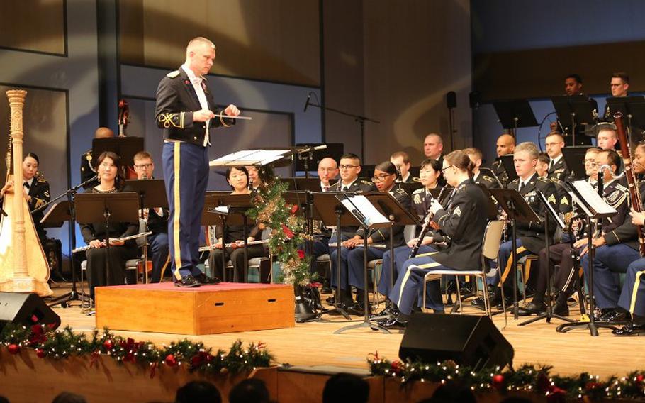 Chief Warrant Officer 2 Richard Chapman, left, commander of the U.S. Army Japan Band, conducts the band during their seventh annual performance, this year titled "An American Concert," held Dec. 20 and 21, 2019, at Zama Harmony Hall in Zama City. (Photo Credit: Noriko Kudo, U.S. Army Garrison Japan Public Affairs)