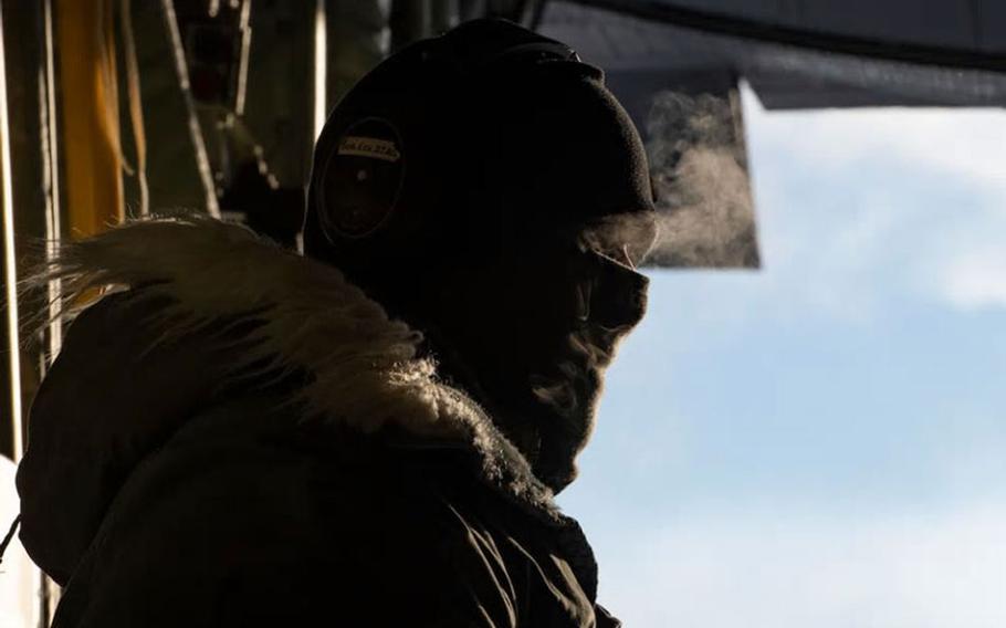 Tech. Sgt. Matt Fryz, 36th Airlift Squadron loadmaster, prepares to close the cargo doors of a C-130J Super Hercules following the final troop off-load as part of exercise Arctic Warrior 21 at Donnelly Training Area, AK, Feb. 8, 2021. (U.S. Air Force photo by Staff Sgt. Gabrielle Spalding)