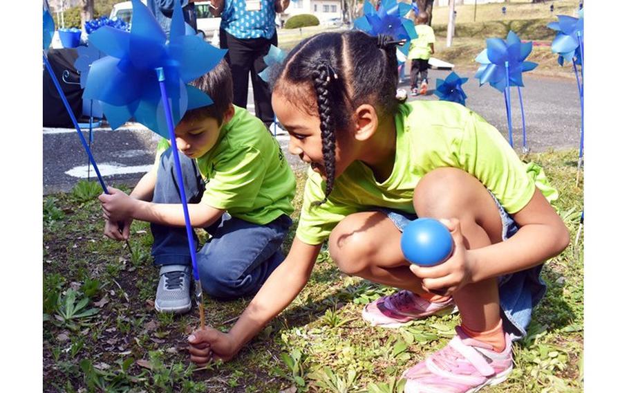 Children from the Camp Zama Child Development Center plant pinwheels for Child Abuse Awareness Month at Camp Zama Army Community Service March 27. (Photo Credit: Wendy Brown, U.S. Army Garrison Japan Public Affairs)