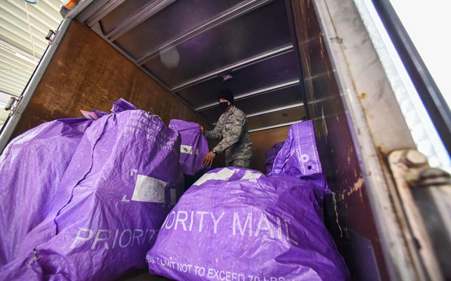 U.S. Air Force Airman 1st Class Kevin Leon, a 35th Force Support Squadron postal clerk, moves mail to the front of the truck to be unloaded at Aomori Airport, Aomori, Japan, May 20, 2020. (U.S. Air Force photo by Staff Sgt. Melanie A. Bulow-Gonterman)