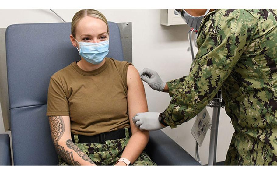 A hospital corpsman prepares a sailor's arm before administering a vaccine at the Navy Medical Readiness and Training Command, Pearl Harbor, Hawaii, immunization clinic. (Photo by Macy Hinds)