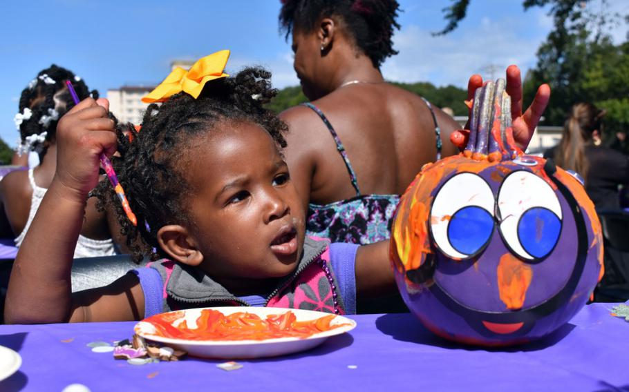 Olivia Harris, 2, decorates a purple pumpkin during the third annual “Purple Pumpkin” event at U.S. Army Garrison Japan Army Community Service at Camp Zama, Japan, Oct. 9, 2019.