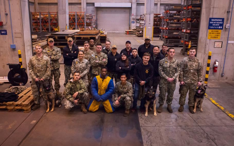 YOKOSUKA, Japan (Jan. 8, 2020) Military working dog handlers from the U.S. Army, Navy, and Air Force, come together for a day of joint training with their K-9s at Commander, Fleet Activities Yokosuka, Japan. MWDs fill an important role at the base in which they are assigned to, protecting government assets by performing weapon, bomb, and drug detection throughout the installation. (U.S. Navy photo by Taylor Curry)