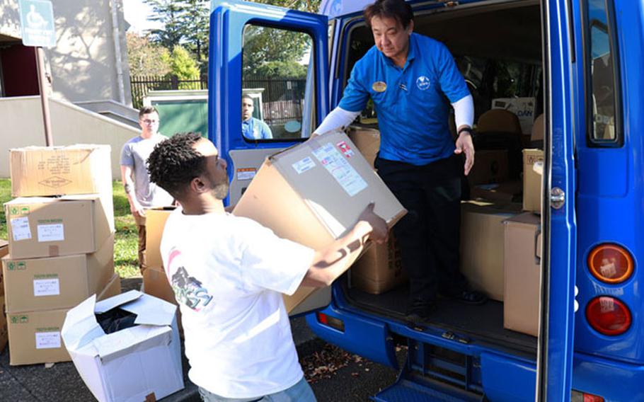 Soldiers with the Better Opportunities for Single Soldiers program, or BOSS, at Camp Zama, Japan, load boxes of care packages on a bus Nov. 15 to deliver them to the Sagamihara South Children's Home and Seikou Gakuen orphanage in nearby Sagamihara City. The Soldiers put the care packages together in Tokyo in October alongside former NBA players as part of the "NBA Cares" program. (Photo Credit: Dustin Perry, U.S. Army Garrison Japan Public Affairs)