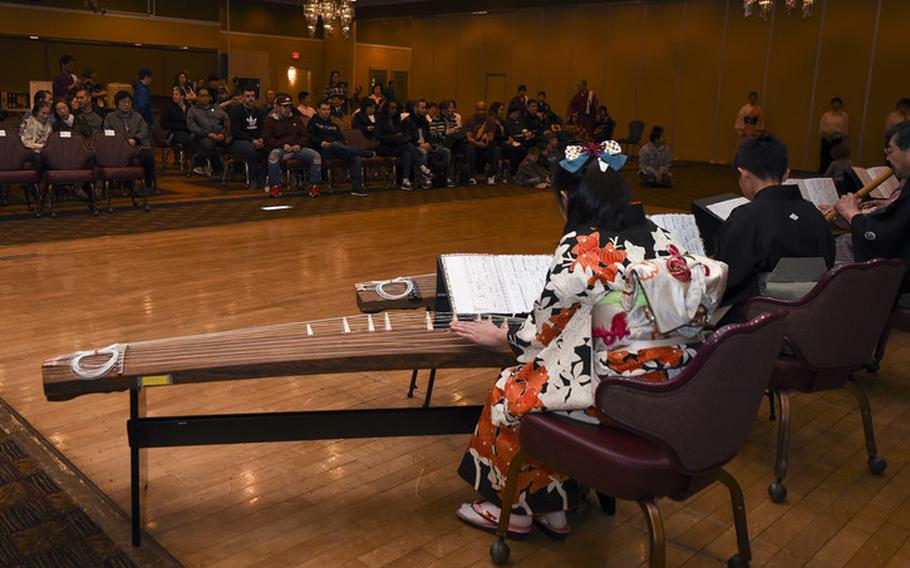 The Wa-wa-wa Club performs with koto strings during the 32nd Annual Japan Day at Misawa Air Base, Japan, April 6, 2019. The Wa-wa-wa Club plays a variety of classical Japanese music with symphonic Japanese instruments across the Aomori prefecture. (U.S. Air Force photo by Branden Yamada)