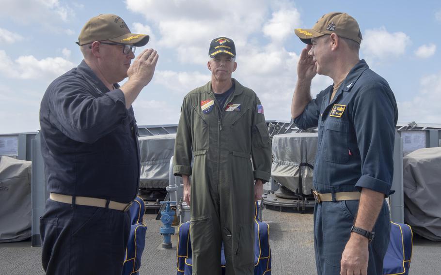 SEA OF JAPAN (Sept. 17, 2019) Rear Adm. Karl Thomas, Commander, Task Force 70 and Carrier Strike Group 5 observes as Capt. Russel Caldwell, left, relieves Capt. James Storm as commanding officer of the Ticonderoga-class guided-missile cruiser USS Antietam (CG 54) during a change of command ceremony. Antietam is forward deployed to the U.S. 7th Fleet area of operations in support of security and stability in the Indo-Pacific region. (Photo by Mass Communication Specialist 2nd Class William McCann)