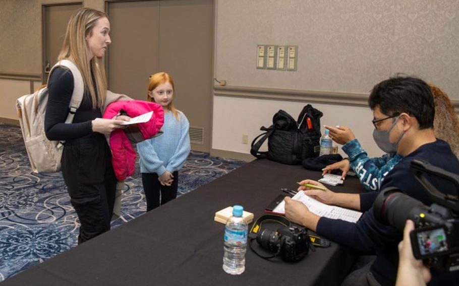 Community members speak to a talent and model agency during a modeling fair at the Camp Zama Community Club in Japan, March 2, 2024. About 200 people attended the event, which also kicked off this year’s Army Emergency Relief campaign.