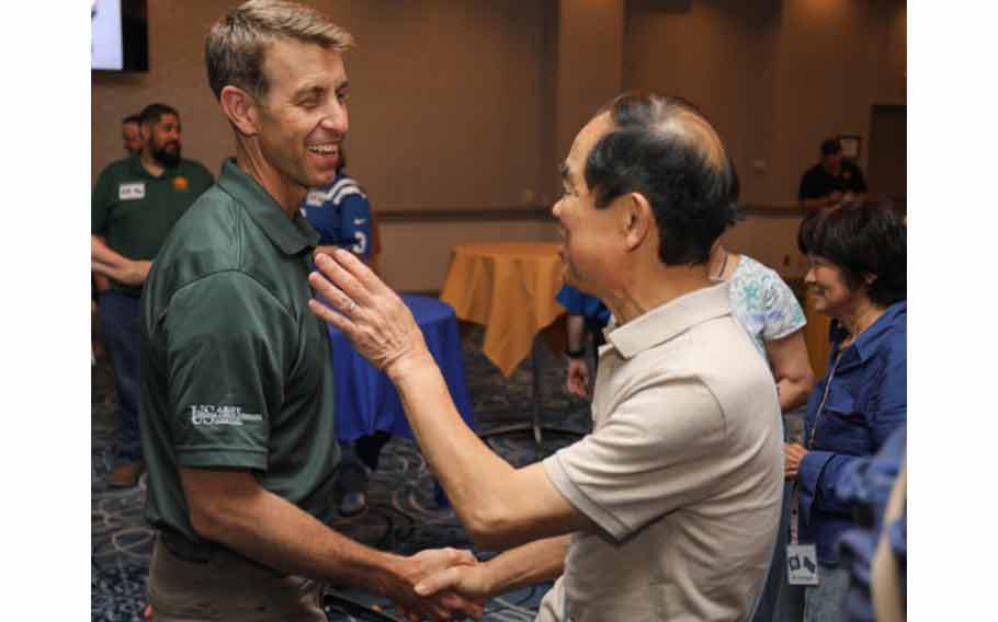 Col. Marcus Hunter, left, commander of U.S. Army Garrison Japan, shakes hands with a member of the Japan-America Society of Central Kanagawa during a “State Day” event at Camp Zama, Japan, June 20, 2024.