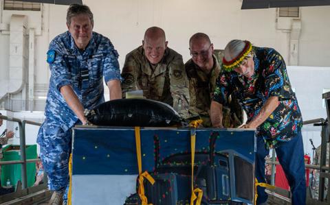 Photo Of Leaders from across the Indo-Pacific theater push a bundle of gifts and supplies into a C-130J Super Hercules during the OCD push ceremony at Andersen Air Force Base, Guam, Dec. 9, 2024.