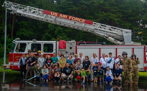 Photo Of U.S. Air Force Airmen assigned to the 35th Civil Engineer Squadron fire department pose with Misawa Friendship Tour participants at Misawa Air Base, Japan, July 19, 2024.