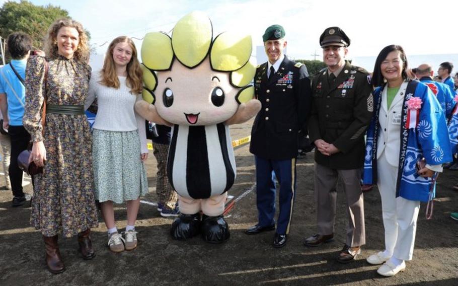 U.S. Army Garrion Japan Commander Col. Marcus Hunter, third from right, and Command Sgt. Maj. David Rio, second from right, pose for a photo with Zama Mayor Mito Sato, right, and Zamarin, the city’s mascot.