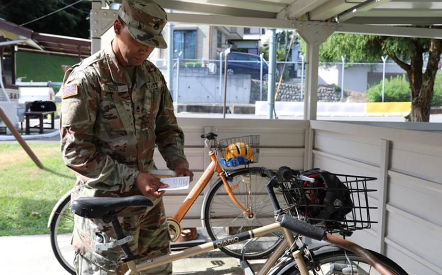 Staff Sgt. Chase Sykes, assigned to the 88th Military Police Detachment, checks bicycles Aug. 8 on Camp Zama in advance of a “bicycle roundup” campaign that will begin Aug. 10 as a way to encourage bicycle and scooter owners on Camp Zama and Sagamihara Family Housing Area to register their vehicles.