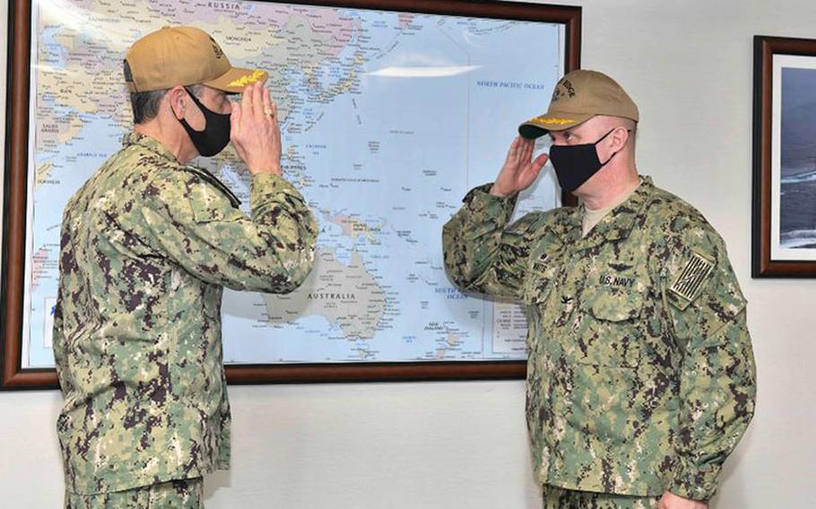 YOKOSUKA, Japan (Feb. 15, 2021) - Outgoing Commanding Officer Capt. Craig Sicola, from Dallas, and newly appointed Commanding Officer Capt. Tim Waits, from Anniston, Alabama, exchange salutes during a change of command ceremony held in the admiral’s cabin aboard U.S. 7th Fleet flagship USS Blue Ridge. Blue Ridge is the oldest operational ship in the Navy and, as 7th Fleet command ship, actively works to foster relationships with allies and partners in the Indo-Pacific Region.