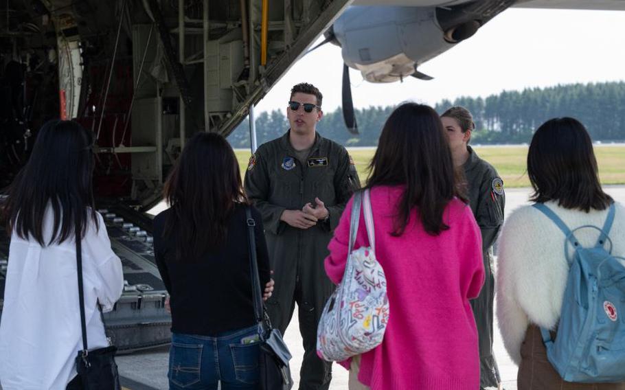 Capt. Alex Atwood, 36th Airlift Squadron pilot, talks about the C-130J Super Hercules to students from the Ambassador’s Youth Council Program while on a tour of Yokota Air Base, Japan, April 21, 2023. Students were able to hear about Yokota Air Bases mission, U.S. Forces Japan, YokoWorx, and experience static displays of a C-130J Super Hercules and UH1-N helicopter. (U.S. Air Force photo by Airman 1st Class Jarrett Smith)