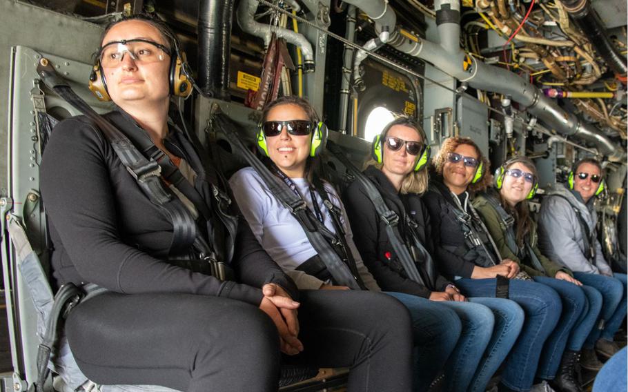 Yokota spouses watch scenery during CV-22 Osprey incentive flight, provided by the 353rd Special Operations Wing, at Yokota Air Base, Japan, May 12, 2023. The incentive flights gave spouses the opportunity to see what America's Air Commandos of the Pacific do to integrate throughout the theater, giving insight into the mission that drives the daily sacrifices made to support their service members. (U.S. Air Force photo by Senior Airman Brooklyn Golightly)