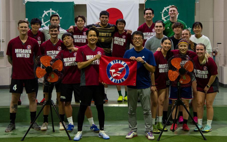 The Misawa United soccer team pose together during a donation ceremony at Misawa Indoor Sports Field in Misawa City, Japan, Sept. 20, 2023. The team donated two fans to the facility to fulfill their goal of giving back to the community. (U.S. Air Force photo by Kohei Sugisawa)