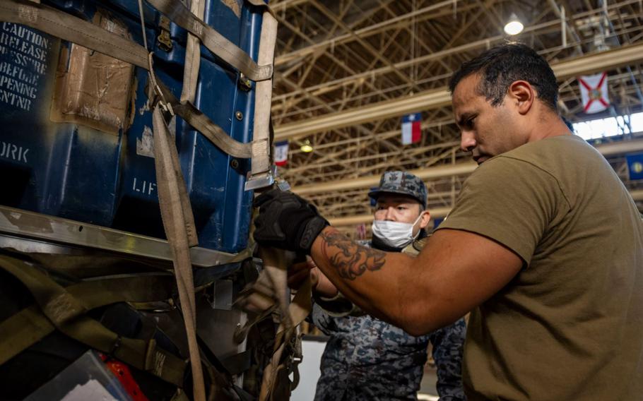 A 35th Logistics Readiness Squadron member secures cargo on a pallet during a Port Dawg Challenge at Misawa Air Base, Japan, Dec. 8, 2023. The challenge tested the competing members’ ability to load a cargo pallet, secure the cargo, and operate heavy equipment. (U.S. Air Force photo by Senior Airman Antwain Hanks)