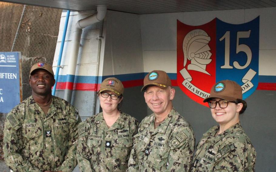 Force Chaplain Capt. Scott Cauble, Force Religious Program Specialist (RPCS) Sandra Hosier, Commander, Task Force (CTF) 71/Destroyer Squadron (DESRON) 15 Chaplain Cmdr. Autumn Butler-Saegar, and Religious Program Specialist Abraham Dukuly pose for a photo in front of CTF 71/DESRON 15. DESRON 15 is the Navy’s largest destroyer squadron, consisting of nine Arleigh Burke-class guided-missile destroyers forward-deployed to Yokosuka, Japan. (U.S. Navy photo by Lt. j.g. Ronan Williams)