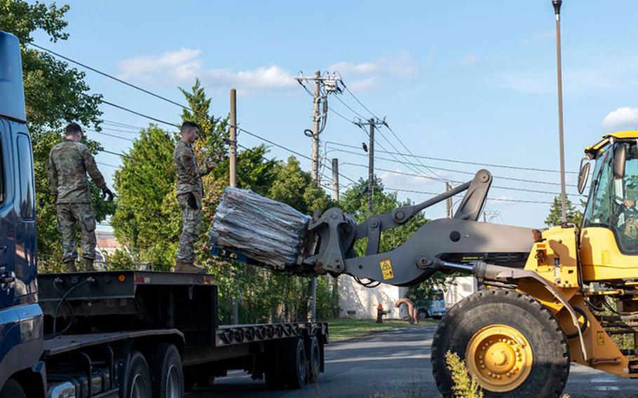 An Airman assigned to the 374th Civil Engineering Squadron drives a forklift past an 18-wheeler loaded with supplemental structural defense equipment at Yokota Air Base, Japan, in support of exercise Beverly Morning 24-1, Oct. 18, 2023. Reinforcing facilities supports Yokota Air Base's ability to respond to any threats and helps ensure continued operational readiness. (U.S. Air Force Public Affairs photo by Senior Airman Hannah Bean)