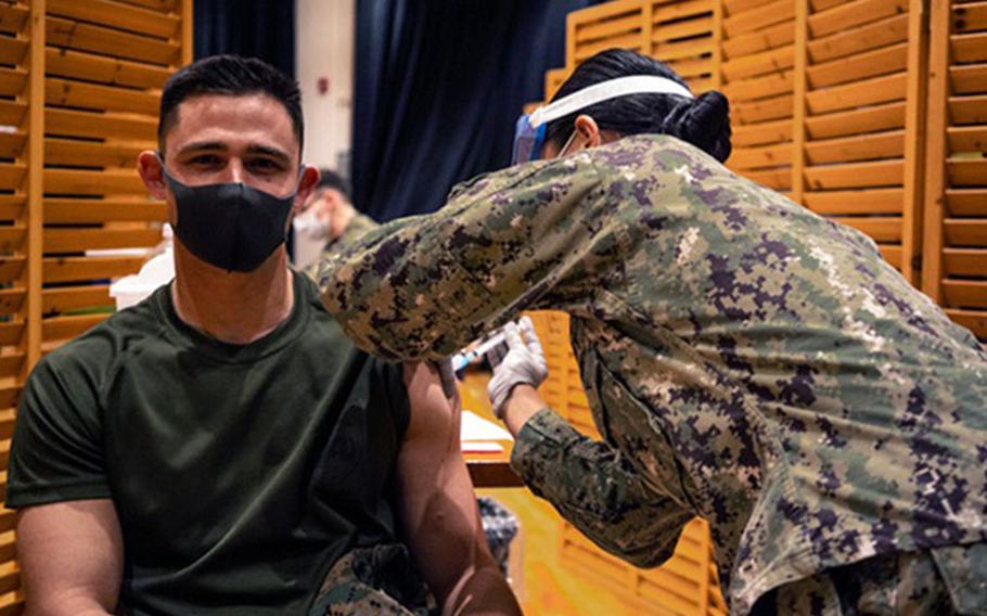 Marines with the 3rd Marine Expeditionary Brigade receive the Moderna COVID-19 vaccination shot on Camp Hansen, Okinawa, Japan on Jan. 20. Receiving the vaccine mitigates risks to military operations, allowing Marines to maintain their readiness and be able to respond to any crisis or contingency in the Indo-Pacific region. (Photo by Marine Cpl. Sarah Marshall, 3rd Marine Expeditionary Brigade.)