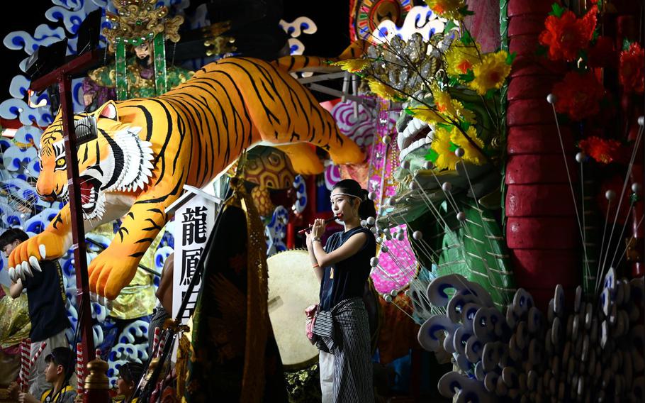 A participant of the Misawa City Festival plays a flute on top of a float at Misawa City, Japan, Aug. 23, 2024.