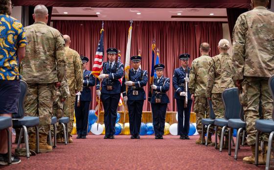 Photo Of Members of the 374th Airlift Wing base honor guard present the colors during a commencement ceremony for Community College of the Air Force graduates in the Officers’ Club at Yokota Air Base.