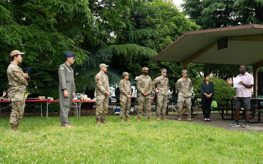 Members of the 374th Airlift Wing listen to remarks from Lloyd Jackson, Yokota Tax Center lead, during a Tax Center Appreciation barbecue at Yokota Air Base, Japan, June 7, 2024.