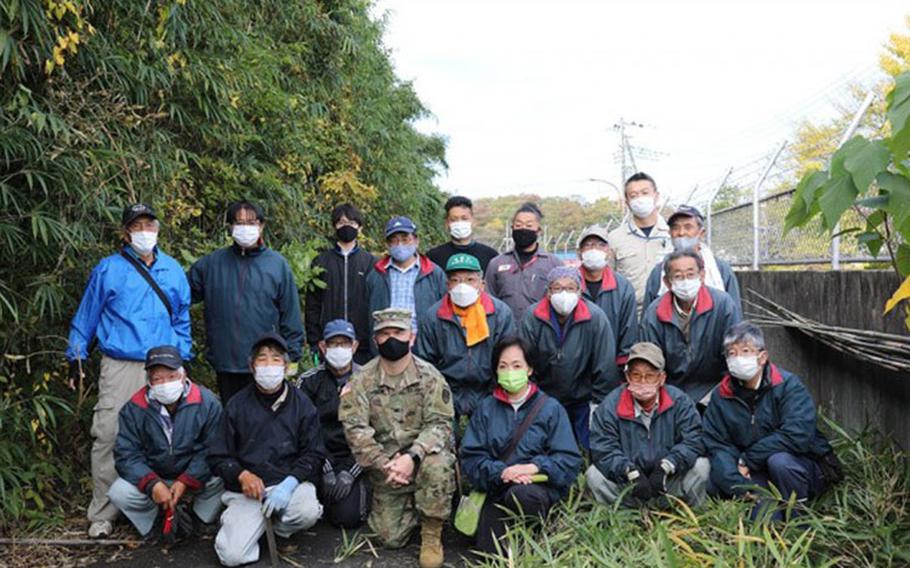 U.S. Army Garrison Japan Commander Col. Christopher L. Tomlinson poses for a photo with members of the Sagami Giant Kite Preservation Association, Kassaka District, Nov. 19 on Camp Zama, Japan. The group was there to harvest bamboo that will be used to construct giant kites for the Sagamihara Giant Kite Festival, scheduled to be held in May 2022. (Photo Credit: Noriko Kudo)