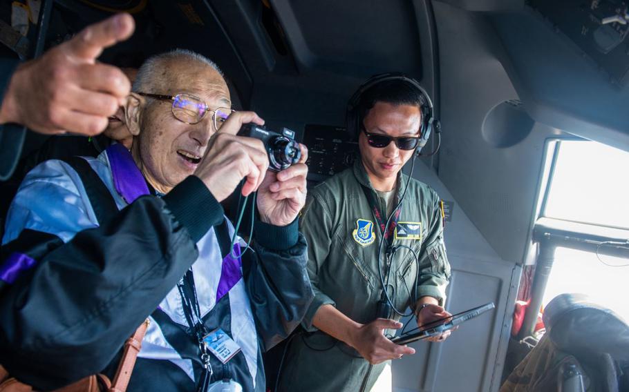 Tadashi Takagi, Ome Yokota Friendship Club president, takes photos from the cockpit of a C-130J Super Hercules assigned to the 36th Airlift Squadron during a civic leader flight at Yokota Air Base, Japan, April 10, 2024.