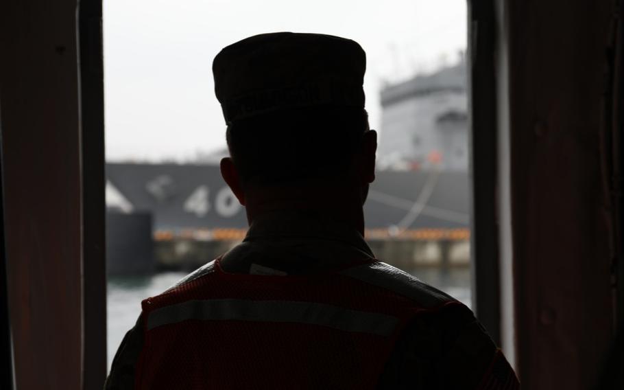 Col. Christopher L. Tomlinson, commander of U.S. Army Garrison Japan, looks out the window of a landing craft mechanized watercraft, or LCM, while being transported from Kure Pier 6 to the Akizuki Ammunition Depot April 25 as part of his final visit to Kure and its various sites before the upcoming end of his tenure as commander. (Noriko Kudo)