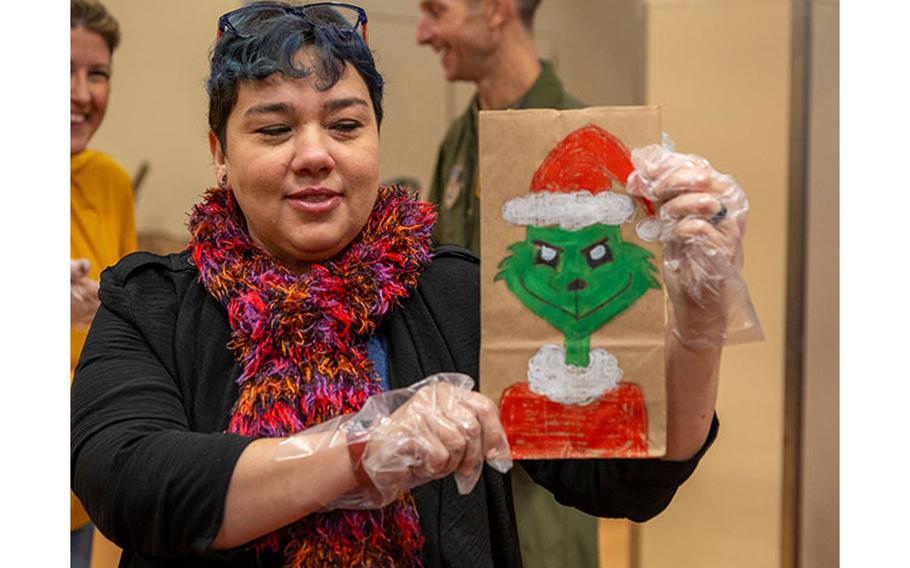 A member of Team Misawa shows off one of the custom-made bags for the annual Cookie Caper at Misawa Air Base, Japan, Dec. 5, 2023.