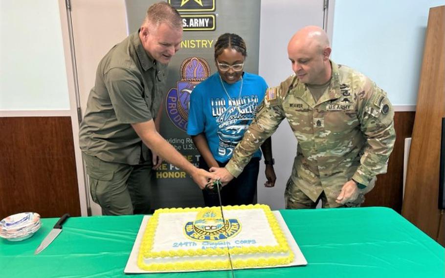 From left, U.S. Army Japan Deputy Command Chaplain (Lt. Col.) Mark Olson, Spc. Mikaila Bell, 311th Military Intelligence Battalion religious affairs specialist; and U.S. Army Japan Command Sgt. Maj. Jeffery Weaver cut the cake during a U.S. Army Chaplain Corps anniversary celebration July 29 in the Camp Zama, Japan, chapel.