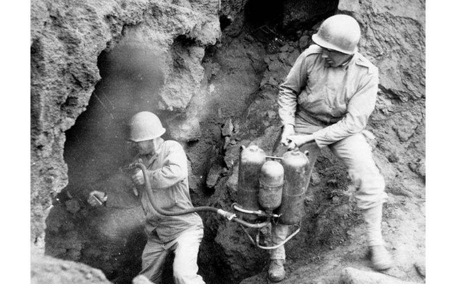 Capt. James T. Kolb of Company A, 147th Infantry, assisted by Sgt. Keogh, uses a flamethrower against dug-in Japanese troops on Iwo Jima, April 20, 1945. Relieving Marine Corps units, the Soldiers of the Ohio National Guard’s 147th Infantry Regiment fought on the island from March to September 1945, clearing the remaining enemy troops, some of whom were hiding in intricate cave systems. (Photo from Ohio Army National Guard Historical Collections)