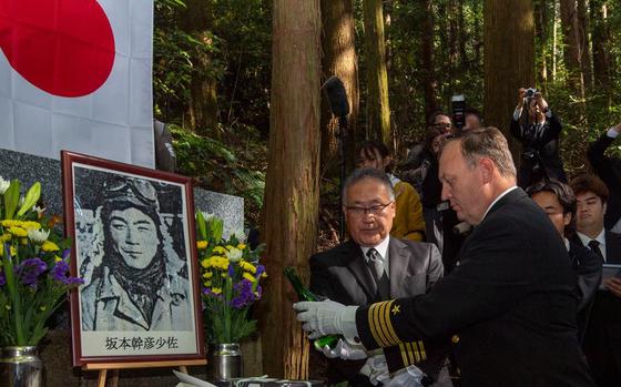 Capt. Michael Fontaine, Commander, Fleet Activities Sasebo, pays homage to the fallen by pouring sake on the downed “Zero” fighter pilot commemorative site during a memorial ceremony held in Isahaya, Japan Nov. 21, 2024.