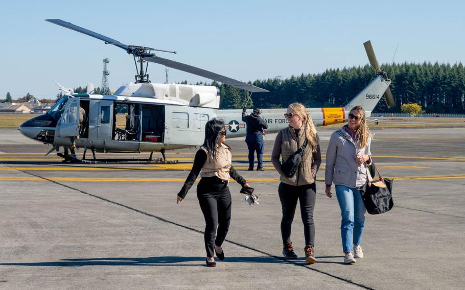 Spouses from Yokota depart a UH-1N Huey assigned to the 459th Airlift Squadron after an orientation flight at Yokota Air Base, Japan.