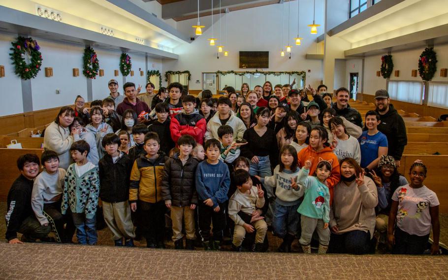 Children from the Biko-en Orphanage pose for a group photo at Misawa Air Base, Japan, Dec. 21, 2024.