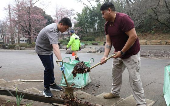 Soldiers assigned to the 5th Transportation Company, 765th Transportation (Terminal) Battalion, clean out drainage ditches during a joint cleanup effort.