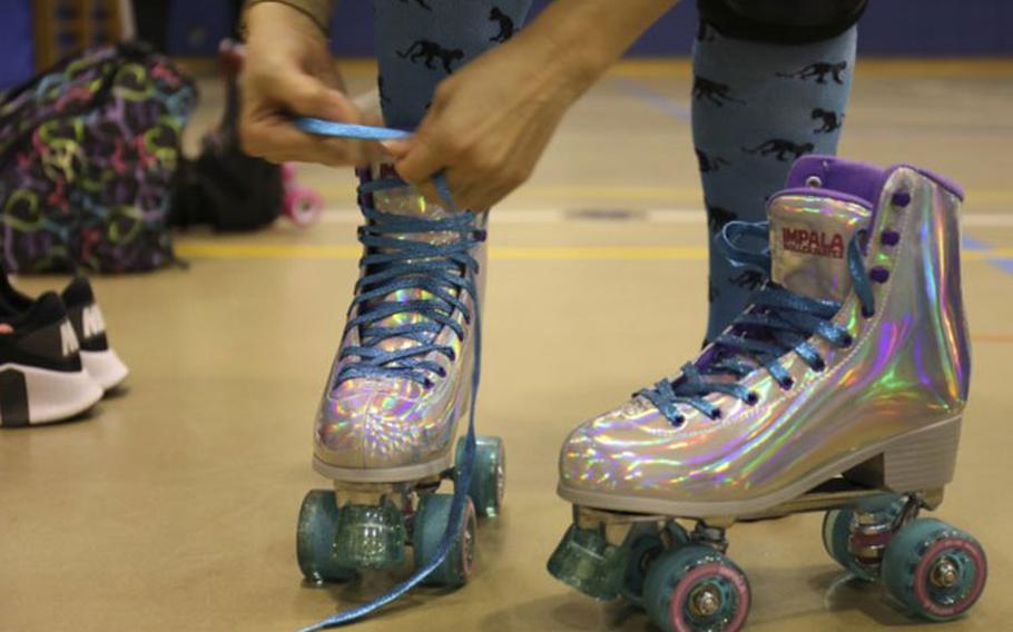 A skater tightens up her skates during a roller derby practice for the Zama Killer Katanas at Arnn Elementary School, Sagamihara Family Housing Area, Japan, Feb. 22, 2022. (Photo Credit: Sean Kimmons)