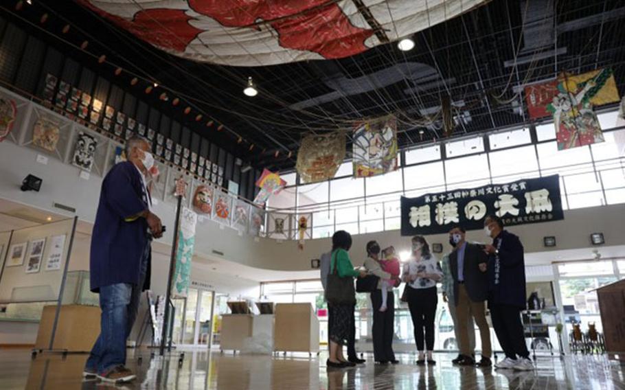 USAG Japan Commander Col. Thomas R. Matelski, USAG Japan Command Sgt. Major Justin Turner and their families view a giant kite hung from the ceiling at the Sagami Giant Kites Center during a visit there near Camp Zama May 12. (Photo Credit: Noriko Kudo, U.S. Army Garrison Japan Public Affairs)