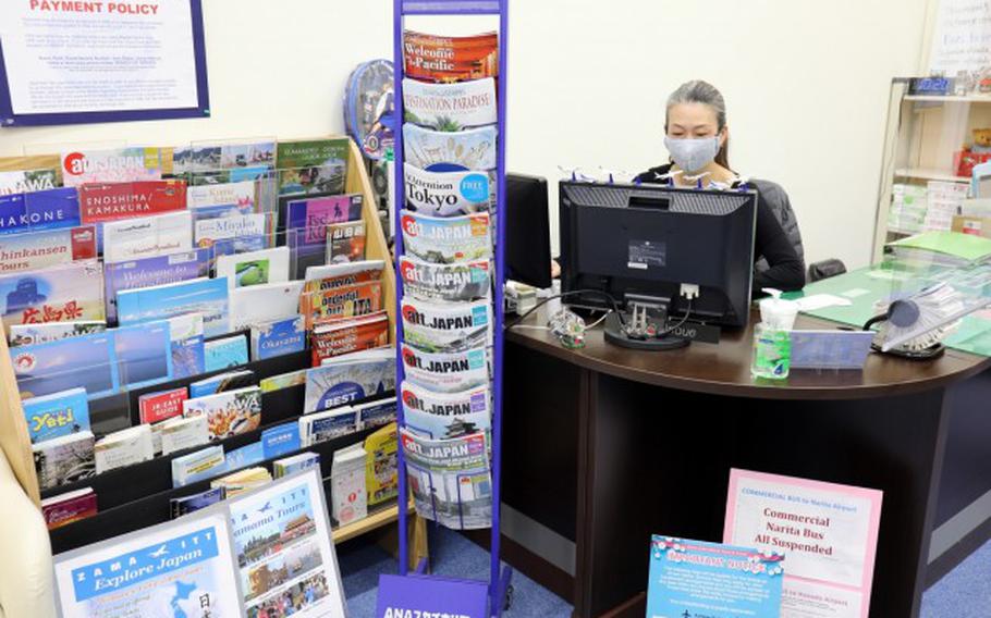 Yuko Inoue, operations officer for Zama ITT, works at her desk in the Zama ITT office, Camp Zama, Japan, Jan. 22. The office is closing Jan. 29 after offering travel services on Camp Zama for 39 years. (Photo Credit: Winifred Brown)