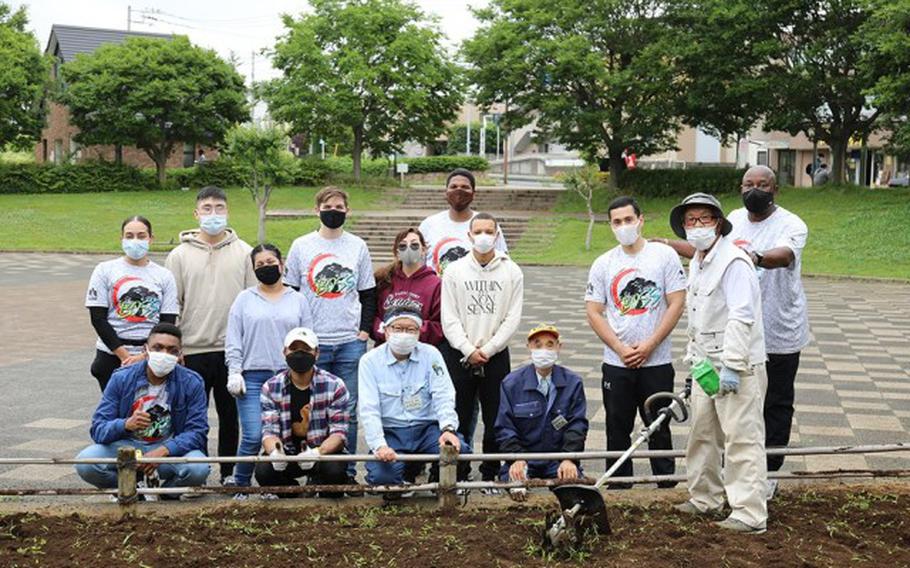 Members of Camp Zama’s Better Opportunities for Single Soldiers program, or BOSS, pose for a group photo with a local volunteer team June 8 at Yatoyama Park near Camp Zama, Japan, after working together there to help pull weeds and cultivate the soil for flower planting. (Noriko Kudo)