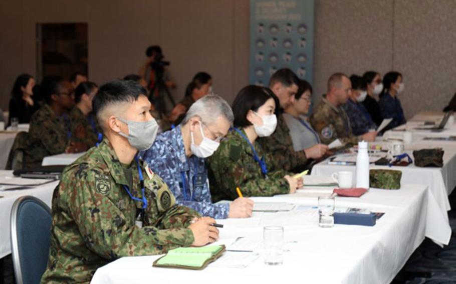 Participants in the U.S. Army Japan's inaugural Women, Peace and Security symposium listen to Maj. Gen. JB Vowell, commander of USARJ, provide remarks inside the Camp Zama Community Club, Japan, March 6, 2023. The three-day event had speakers, panel discussions and breakout sessions to promote a gendered perspective and women’s equal involvement in decision-making. (Photo Credit: Sean Kimmons)