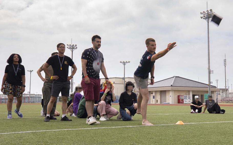 U.S. Marine Corps Lance Cpl. Kaden Wobse, an expeditionary firefighting and rescue specialist with Marine Wing Support Squadron (MWSS) 171, Marine Aircraft Group (MAG) 12, 1st Marine Aircraft Wing (MAW), plays a game of cornhole.