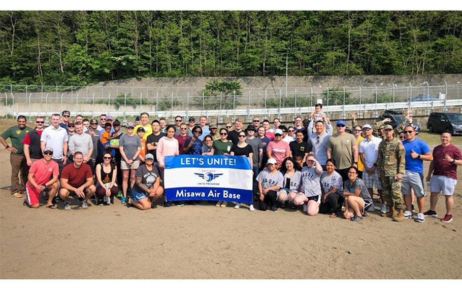 U.S. Air Force members from the 35th Medical Group pose for a photo with a Unite sign after participating in physical activities funded by the Unite program, at Misawa Air Base, Japan, May 29, 2022. Unite funds can be used for activities and food but must be recreational and cohesive in nature. (Courtesy photo by Ronald Stark)