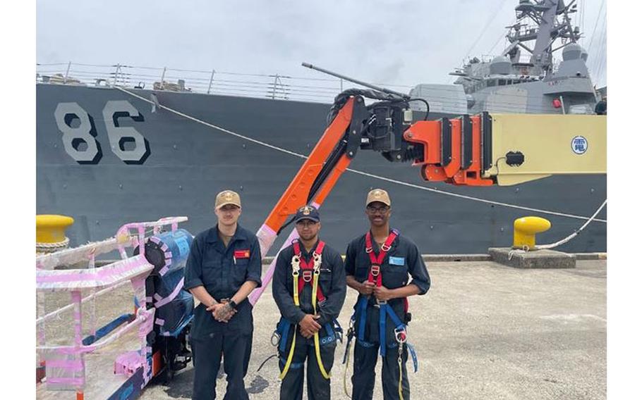 Photo By Ensign Jayla Darby | Members from Deck division after a long day of painting.