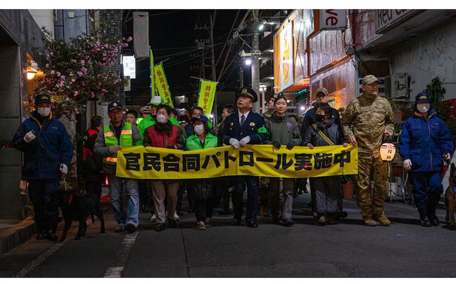 U.S. Air Force Col. Andrew Roddan (far right), 374th Airlift Wing commander, walks with members of the Fussa Police Department and the local community in Fussa, Japan, during a joint safety patrol Dec. 22, 2023. The patrol began at Fussa Station and continued along popular streets for nightlife. (U.S. Air Force photo by Airman 1st Class Samantha White)