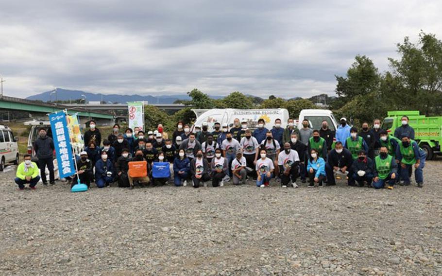 Volunteers who worked together pose for a group photo following a bilateral clean-up event Oct. 25 at the Sagami River near Camp Zama, Japan. The volunteer effort was a partnership with Zama City. (Photo Credit: Noriko Kudo)