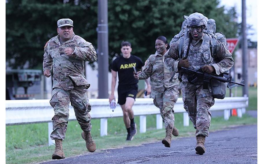 Sgt. Marino Cabral, right, assigned to the 35th Combat Sustainment Support Battalion, competes in the ruck march portion of the unit’s first ever battalion-level “Best Warrior” competition with support from his sponsor, Staff Sgt. Rabindra Thapa, left, Sept. 28 at Sagami General Depot, Japan. (Photo Credit: Noriko Kudo)