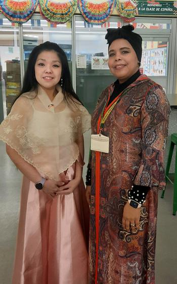 Anne Caballero, of the Philippines, and Khadija Baboulene, of Morocco, wear their native garb during a culural celebration at Edgren Middle High School.