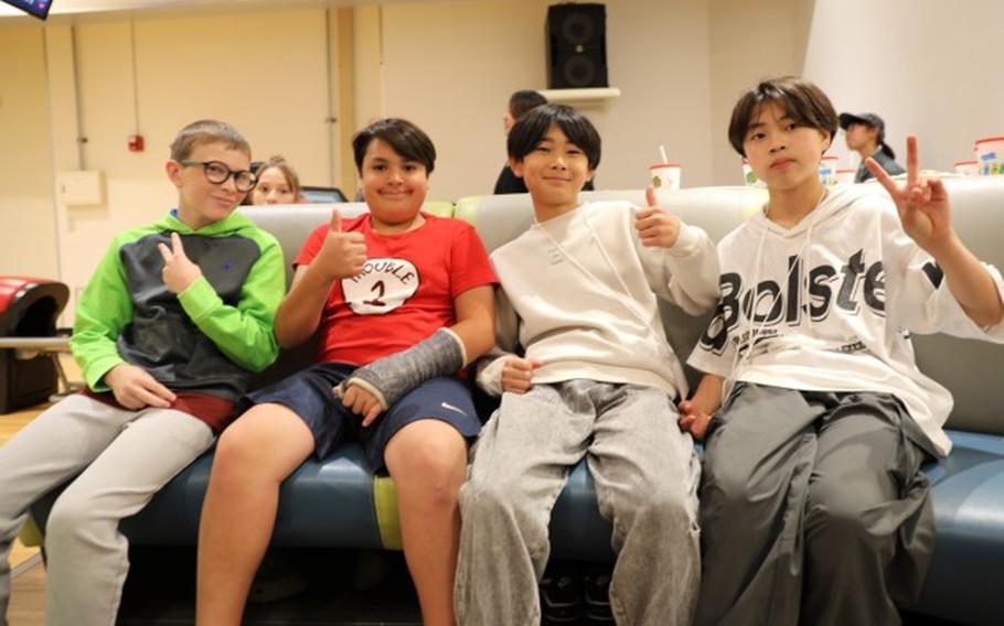 Sota Shinohara, second from right, a seventh grader from the city of Sagamihara, poses for a photo with other American and Japanese students May 31 at the bowling center on Camp Zama, Japan.